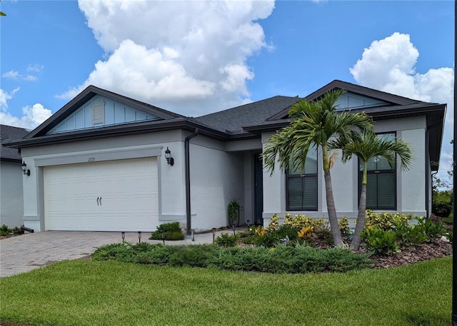 2729 Gabel Oak Dr, North Port, FL 34289 - single story home with stucco siding, decorative driveway, a garage, a front lawn, and roof with shingles