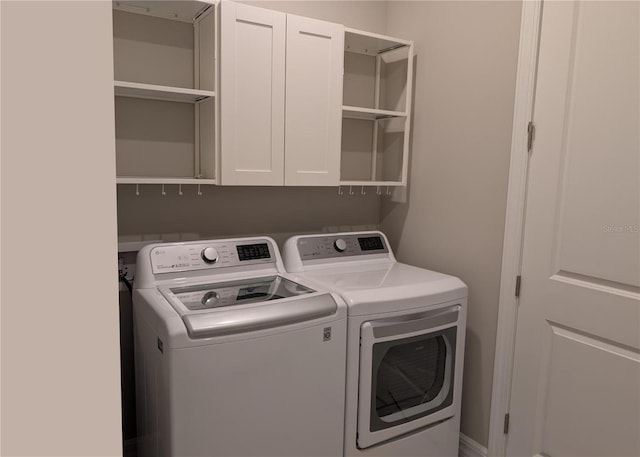 2729 Gabel Oak Dr, North Port, FL 34289 - laundry area featuring independent washer and dryer and cabinet space