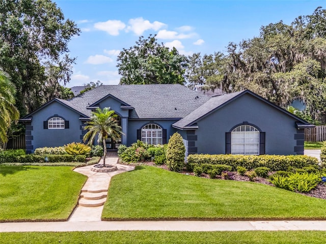 315 Lake Rd, Lake Mary, FL 32746 - ranch-style house with stucco siding, a shingled roof, and a front lawn