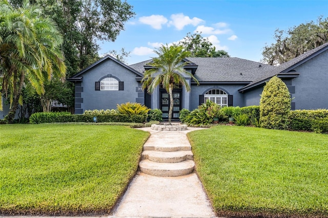 315 Lake Rd, Lake Mary, FL 32746 - ranch-style house featuring stucco siding, a front yard, and a shingled roof