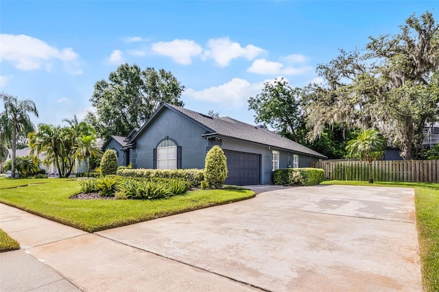315 Lake Rd, Lake Mary, FL 32746 - view of side of property with stucco siding, driveway, and an attached garage