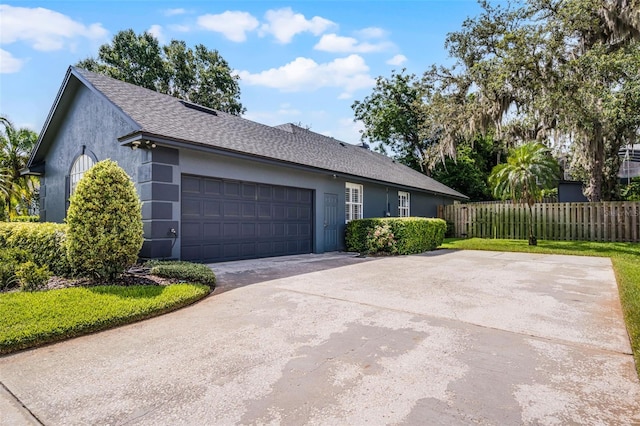 315 Lake Rd, Lake Mary, FL 32746 - view of home's exterior with a garage, stucco siding, a shingled roof, and driveway