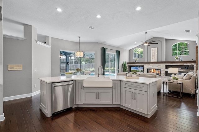 315 Lake Rd, Lake Mary, FL 32746 - kitchen with stainless steel dishwasher, a ceiling fan, vaulted ceiling, dark wood finished floors, and a kitchen island with sink
