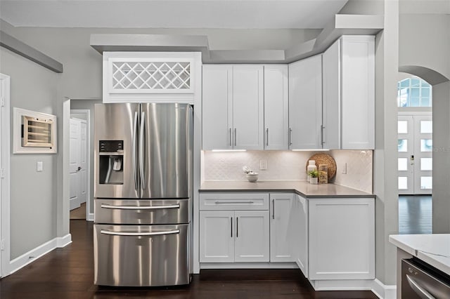 315 Lake Rd, Lake Mary, FL 32746 - kitchen with appliances with stainless steel finishes, decorative backsplash, light countertops, and dark wood-type flooring