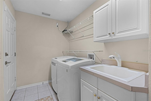 315 Lake Rd, Lake Mary, FL 32746 - laundry room featuring cabinet space, washer and dryer, and light tile patterned floors