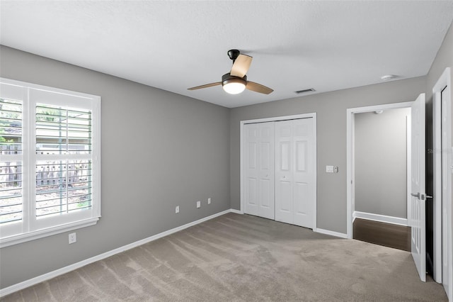 315 Lake Rd, Lake Mary, FL 32746 - unfurnished bedroom with carpet floors, a closet, and a ceiling fan