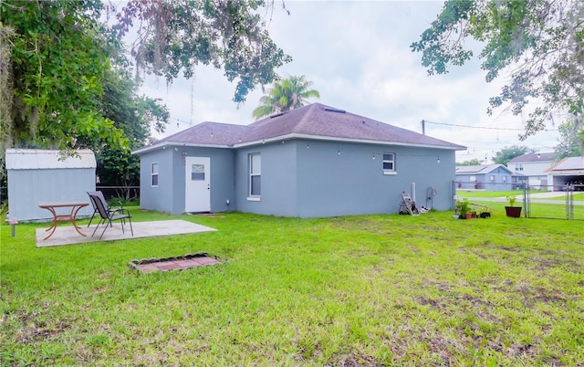 339 Colony Ct, Kissimmee, FL 34758 - rear view of house featuring a patio area, stucco siding, and an outdoor structure