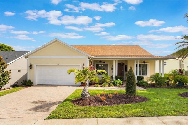 930 Willow Oak Loop, Minneola, FL 34715 - single story home featuring a ceiling fan, stucco siding, a front lawn, and decorative driveway