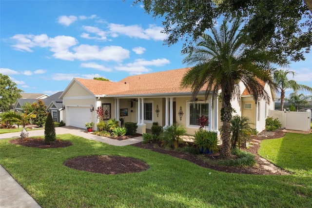 930 Willow Oak Loop, Minneola, FL 34715 - ranch-style home with stucco siding, a garage, ceiling fan, concrete driveway, and a porch