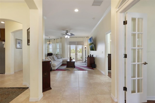 930 Willow Oak Loop, Minneola, FL 34715 - living area featuring arched walkways, french doors, ceiling fan, light tile patterned floors, and crown molding