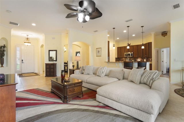 930 Willow Oak Loop, Minneola, FL 34715 - living room featuring arched walkways, ornamental molding, light tile patterned flooring, a ceiling fan, and recessed lighting