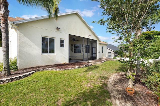 930 Willow Oak Loop, Minneola, FL 34715 - rear view of house featuring a ceiling fan, stucco siding, and a lawn