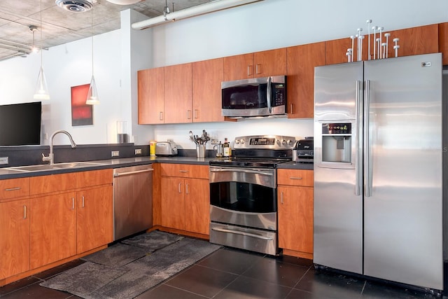 10 N Summerlin Ave Unit 14, Orlando, FL 32801 - kitchen featuring appliances with stainless steel finishes, dark countertops, brown cabinets, and a towering ceiling