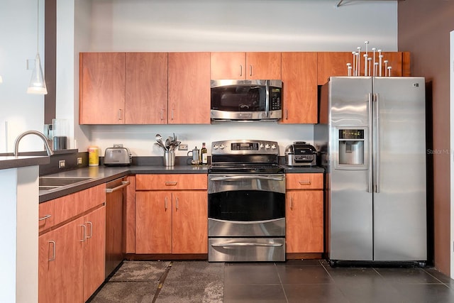 10 N Summerlin Ave Unit 14, Orlando, FL 32801 - kitchen with appliances with stainless steel finishes, dark countertops, and brown cabinets