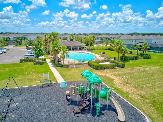 2149 Tudor Rose Dr, Sanford, FL 32773 - communal playground featuring a yard, a residential view, and an outdoor pool