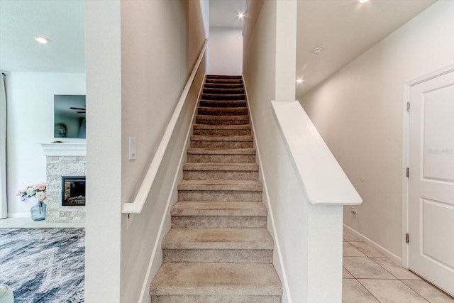 2149 Tudor Rose Dr, Sanford, FL 32773 - staircase featuring tile patterned floors, a fireplace, and recessed lighting