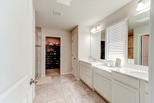 2149 Tudor Rose Dr, Sanford, FL 32773 - bathroom featuring a spacious closet, double vanity, and a shower stall