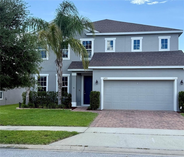 3472 Gretchen Dr, Ocoee, FL 34761 - view of front facade with stucco siding, decorative driveway, a front yard, and a shingled roof