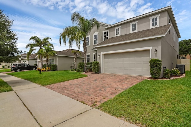 3472 Gretchen Dr, Ocoee, FL 34761 - traditional home featuring stucco siding, decorative driveway, a garage, a front yard, and a shingled roof