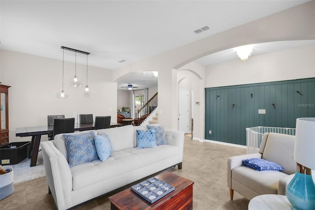 3472 Gretchen Dr, Ocoee, FL 34761 - tiled living area with arched walkways, a ceiling fan, and stairway