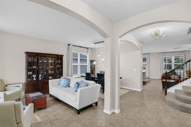 3472 Gretchen Dr, Ocoee, FL 34761 - living room featuring arched walkways and stairway