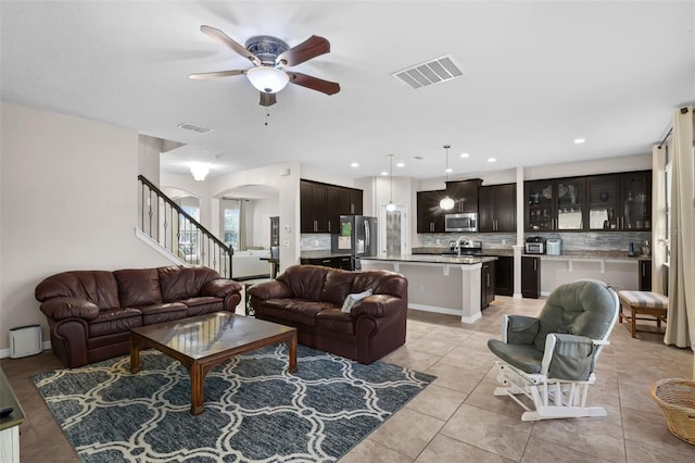 3472 Gretchen Dr, Ocoee, FL 34761 - living area with ceiling fan, stairs, light tile patterned flooring, arched walkways, and recessed lighting