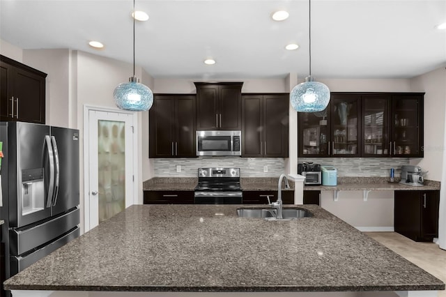 3472 Gretchen Dr, Ocoee, FL 34761 - kitchen with stainless steel appliances, backsplash, dark stone counters, and recessed lighting