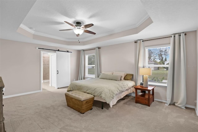3472 Gretchen Dr, Ocoee, FL 34761 - bedroom with a tray ceiling, ornamental molding, light colored carpet, a barn door, and a ceiling fan