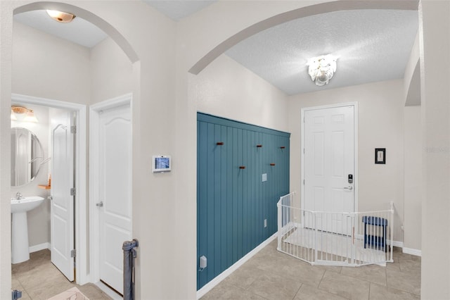 3472 Gretchen Dr, Ocoee, FL 34761 - entrance foyer with light tile patterned flooring, a textured ceiling, and arched walkways
