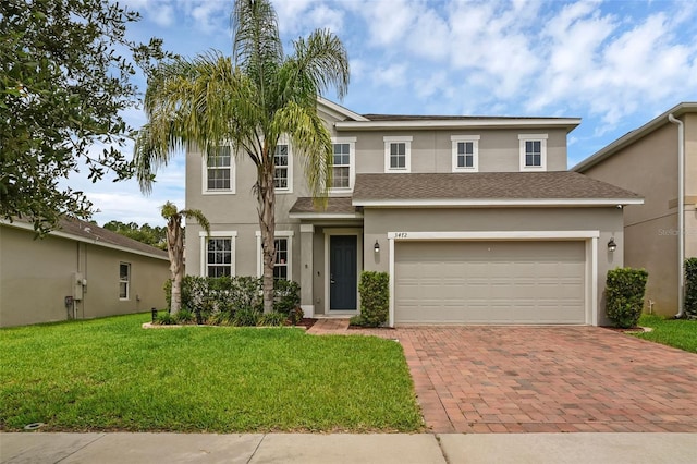 3472 Gretchen Dr, Ocoee, FL 34761 - traditional-style home featuring stucco siding, decorative driveway, a front yard, and an attached garage