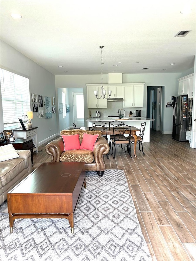 2042 Key Bay Trl, Kissimmee, FL 34747 - living area with light wood-type flooring, a chandelier, and recessed lighting