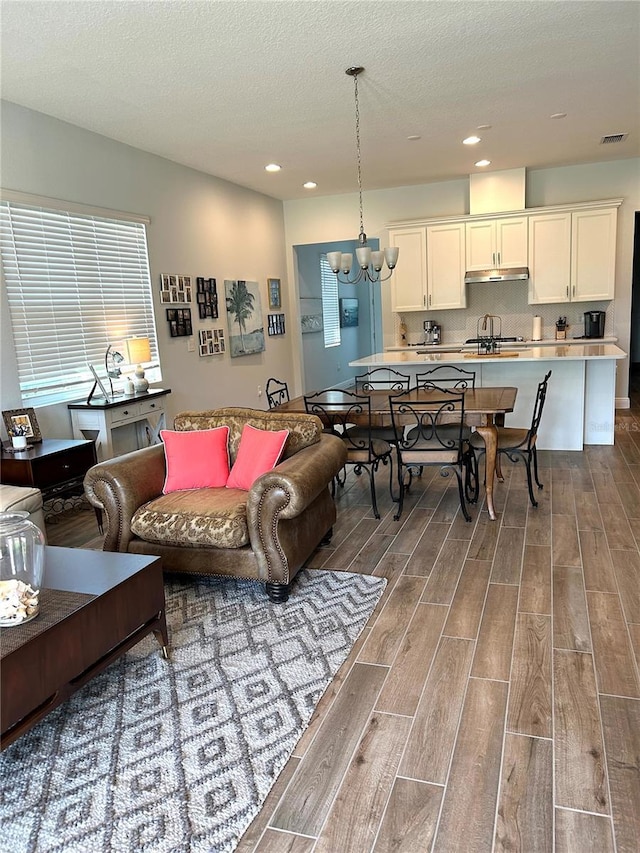 2042 Key Bay Trl, Kissimmee, FL 34747 - living area with wood finished floors, a chandelier, recessed lighting, and a textured ceiling