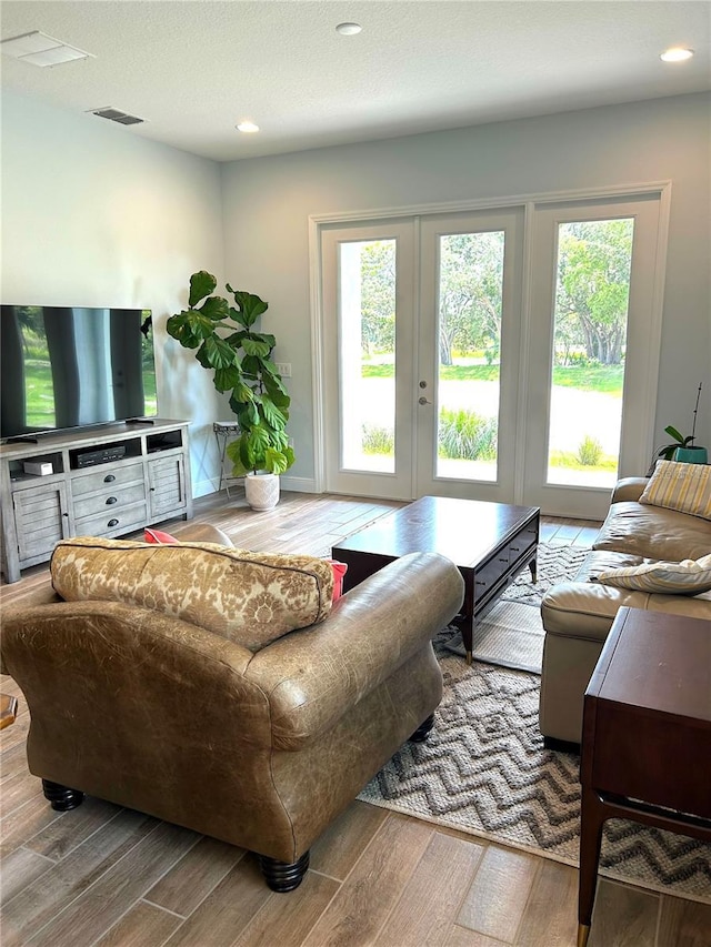 2042 Key Bay Trl, Kissimmee, FL 34747 - living room featuring wood finished floors, recessed lighting, and french doors