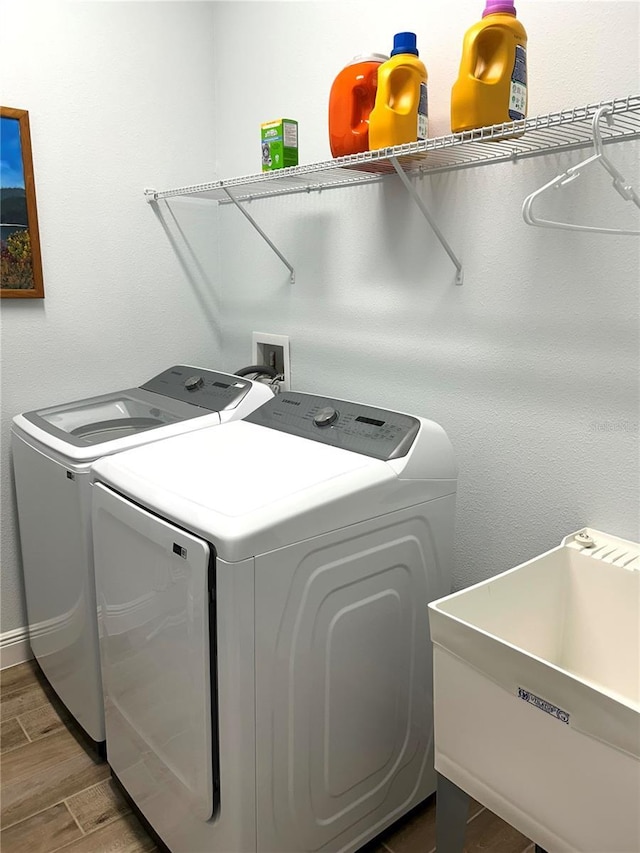2042 Key Bay Trl, Kissimmee, FL 34747 - laundry area with washing machine and clothes dryer and wood finished floors