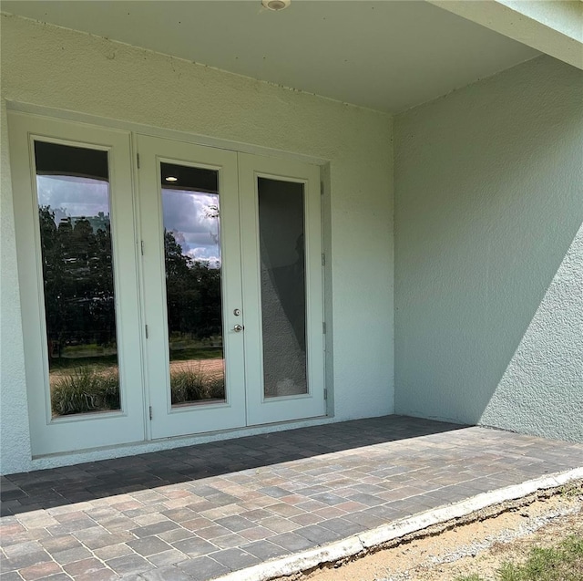 2042 Key Bay Trl, Kissimmee, FL 34747 - property entrance featuring french doors, stucco siding, and a patio area