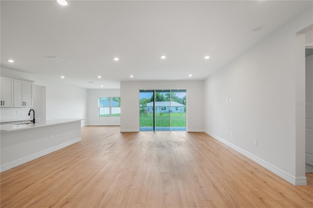 5908 SW 115 Street Rd, Ocala, FL 34476 - unfurnished living room with light wood-style floors and recessed lighting
