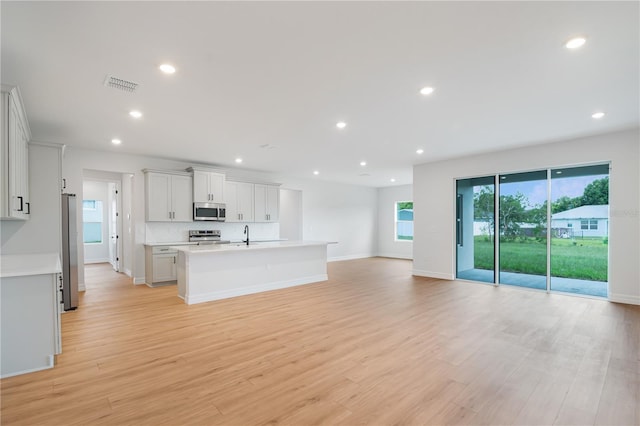 5908 SW 115 Street Rd, Ocala, FL 34476 - unfurnished living room with light wood-style floors and recessed lighting