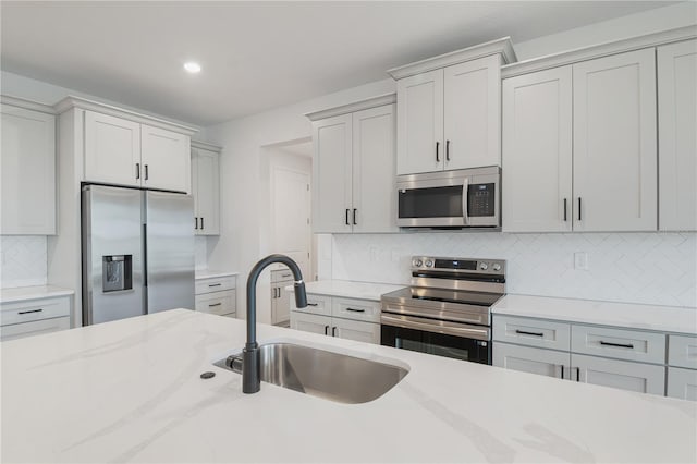 5908 SW 115 Street Rd, Ocala, FL 34476 - kitchen with appliances with stainless steel finishes, decorative backsplash, recessed lighting, and light stone counters
