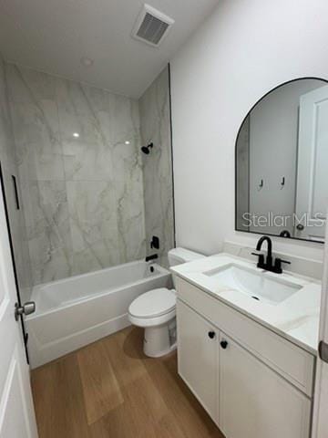 2664 SW De Groodt Rd, Palm Bay, FL 32908 - full bathroom with wood finished floors, vanity, and bathing tub / shower combination
