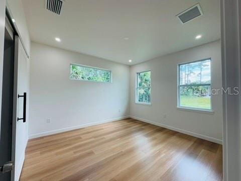 2664 SW De Groodt Rd, Palm Bay, FL 32908 - unfurnished bedroom featuring light wood finished floors and recessed lighting