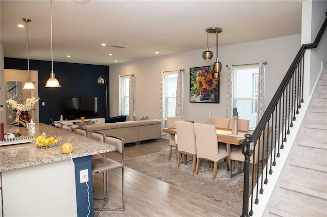 5963 Glory Bower Dr, Winter Garden, FL 34787 - dining room with stairway, light wood-style flooring, and recessed lighting