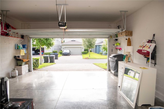 5963 Glory Bower Dr, Winter Garden, FL 34787 - garage featuring a garage door opener and concrete block wall