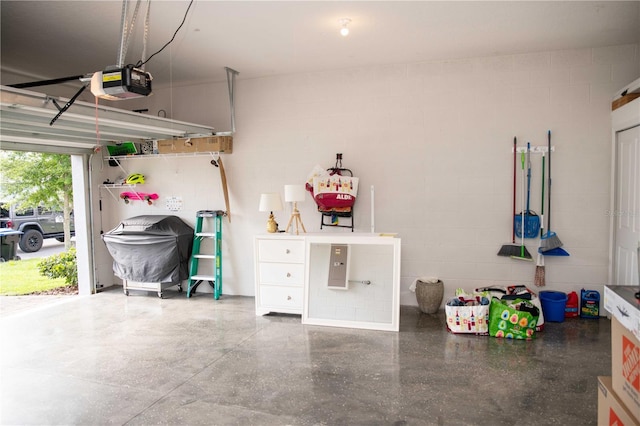 5963 Glory Bower Dr, Winter Garden, FL 34787 - garage featuring a garage door opener and concrete block wall