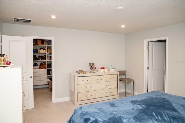 5963 Glory Bower Dr, Winter Garden, FL 34787 - bedroom featuring a spacious closet, light colored carpet, a textured ceiling, recessed lighting, and a closet