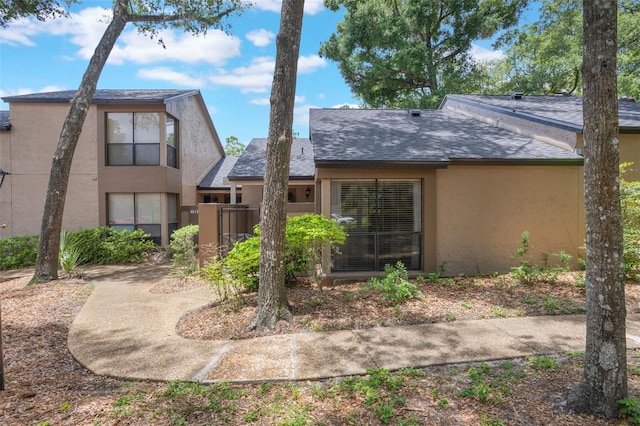 940 Douglas Ave Unit 159, Altamonte Springs, FL 32714 - back of house featuring stucco siding and roof with shingles