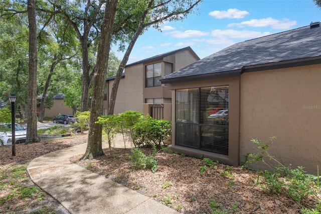 940 Douglas Ave Unit 159, Altamonte Springs, FL 32714 - view of side of home featuring stucco siding and a shingled roof