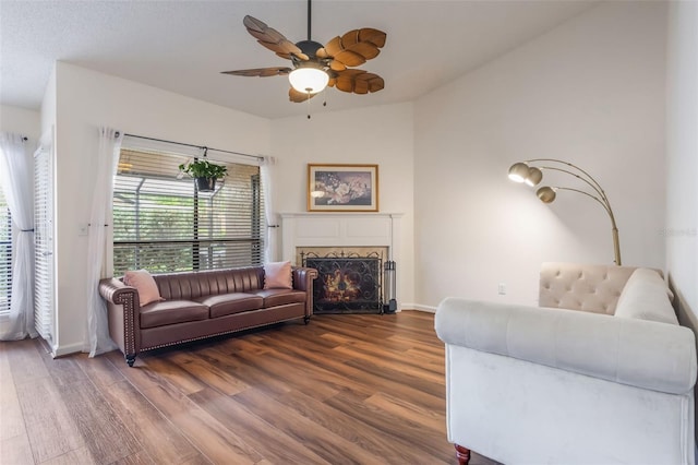 940 Douglas Ave Unit 159, Altamonte Springs, FL 32714 - living room featuring dark wood-style floors, ceiling fan, and a warm lit fireplace