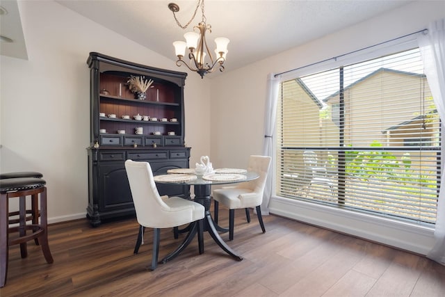 940 Douglas Ave Unit 159, Altamonte Springs, FL 32714 - dining area featuring a chandelier, dark wood-style flooring, and lofted ceiling