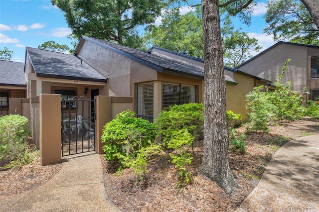 940 Douglas Ave Unit 159, Altamonte Springs, FL 32714 - view of front of property with a gate, roof with shingles, and stucco siding