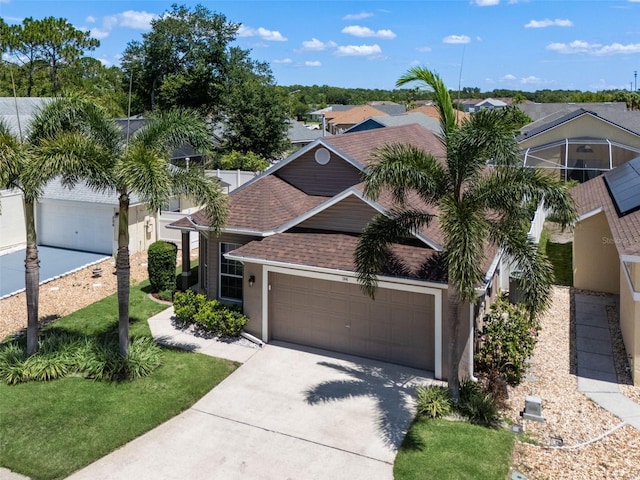 144 Bridgeton St, Davenport, FL 33896 - view of front of home with a shingled roof, concrete driveway, an attached garage, and stucco siding
